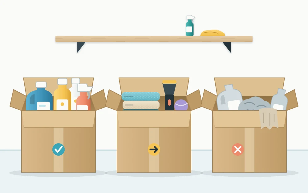 Three open cardboard boxes in a row on the floor holding upright detergent bottles, folded towels and household items, and empty bottles with worn rags
