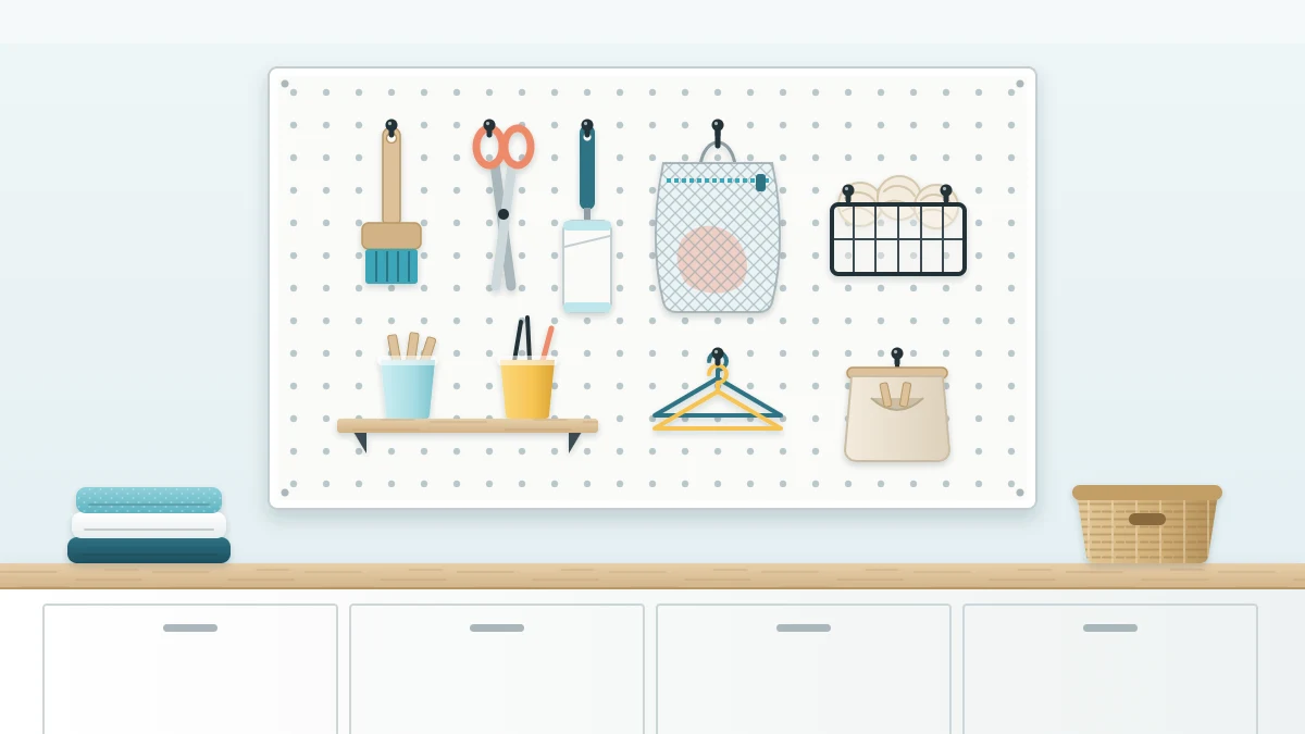 A white pegboard above a wooden counter with hooks holding a brush, scissors, a lint roller, a mesh bag and a small wire basket of wool dryer balls