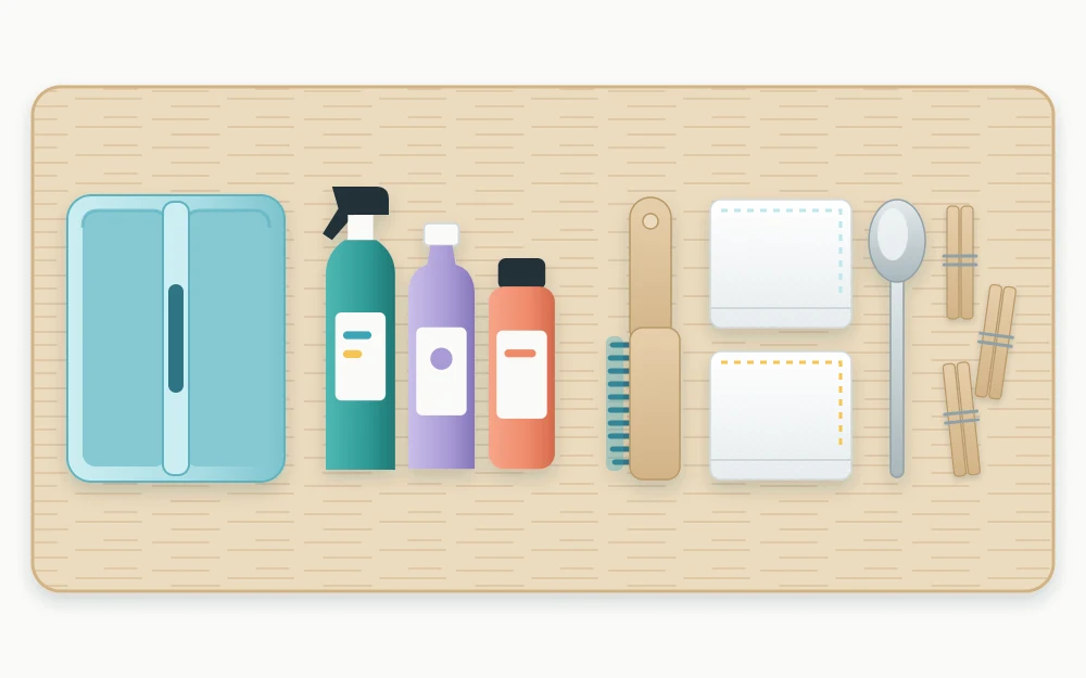 Stain kit laid out in a row: a handled caddy, three upright bottles, a soft brush, white cloths, a spoon and clothespins